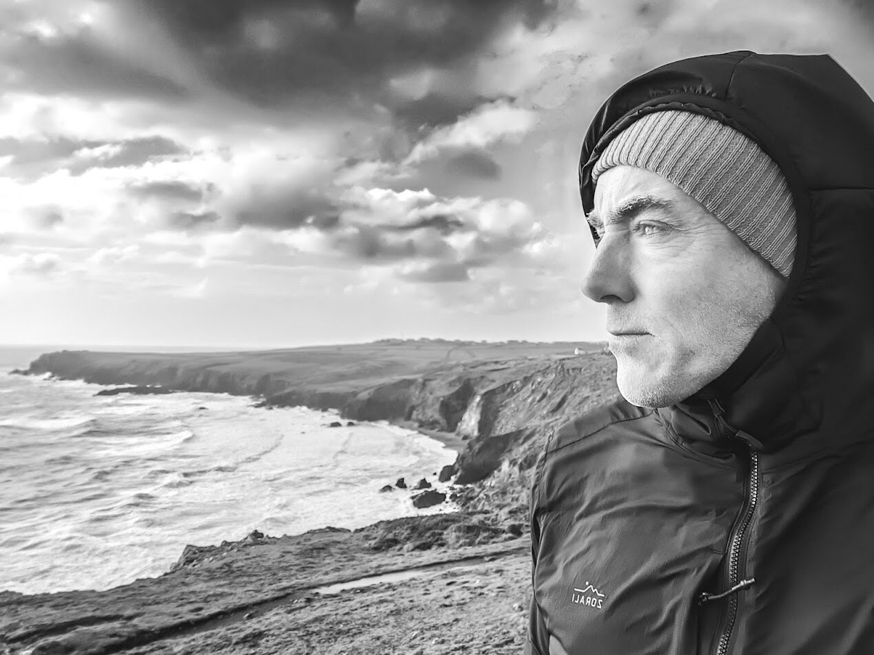 Mark Mathieson overlooking a rugged coastline